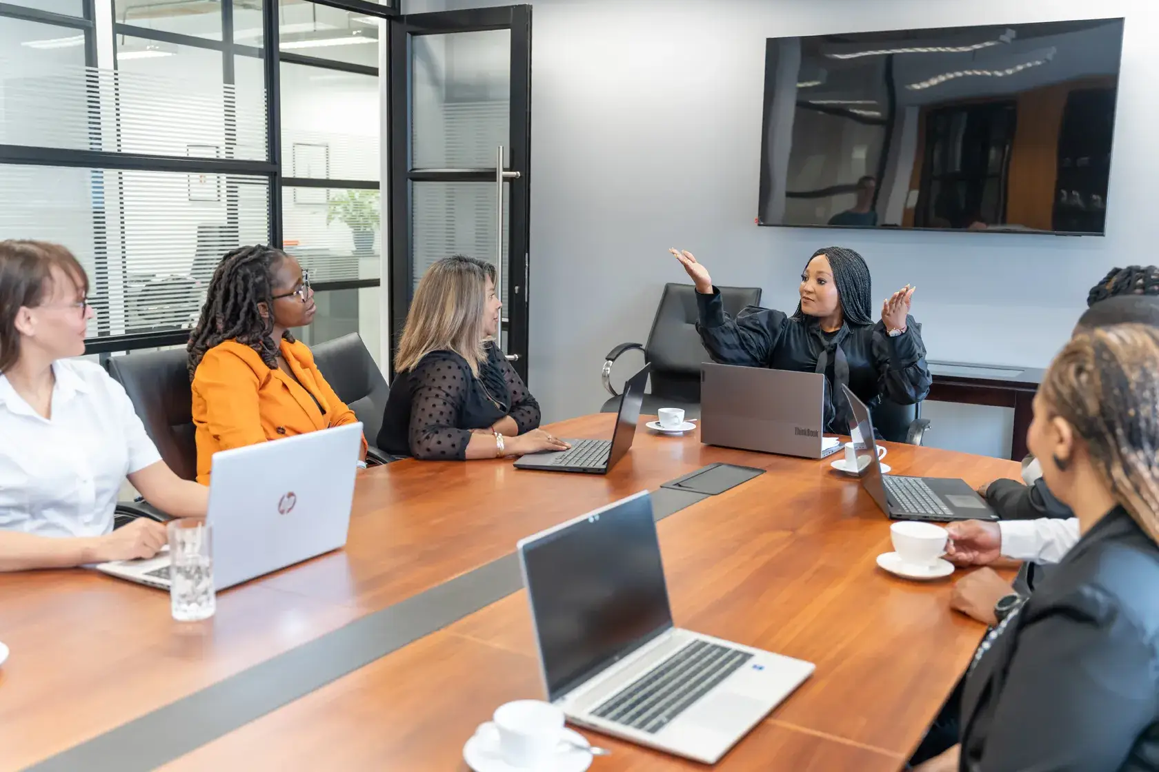 Team meeting in modern conference room with laptops